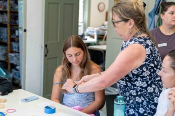 Woman and girl working on crafts